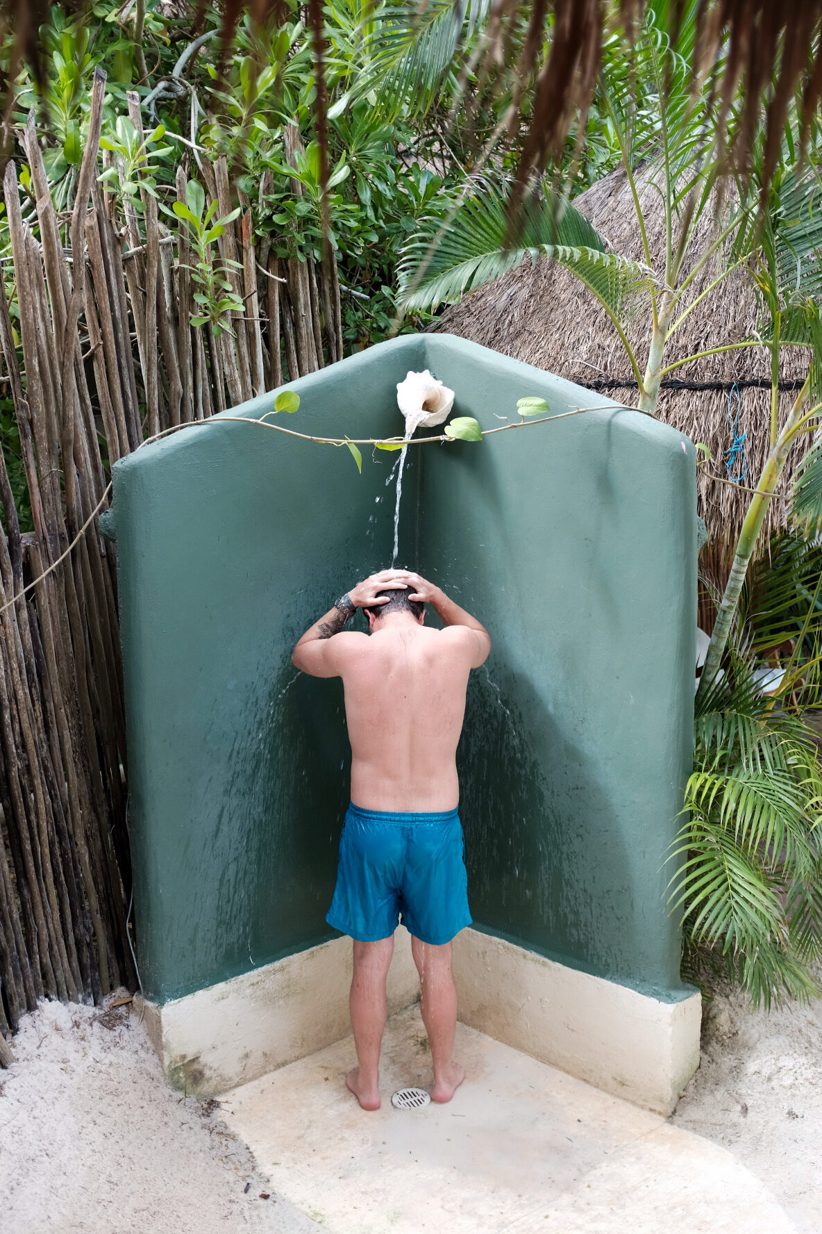 Outdoor shower surrounded by greenery